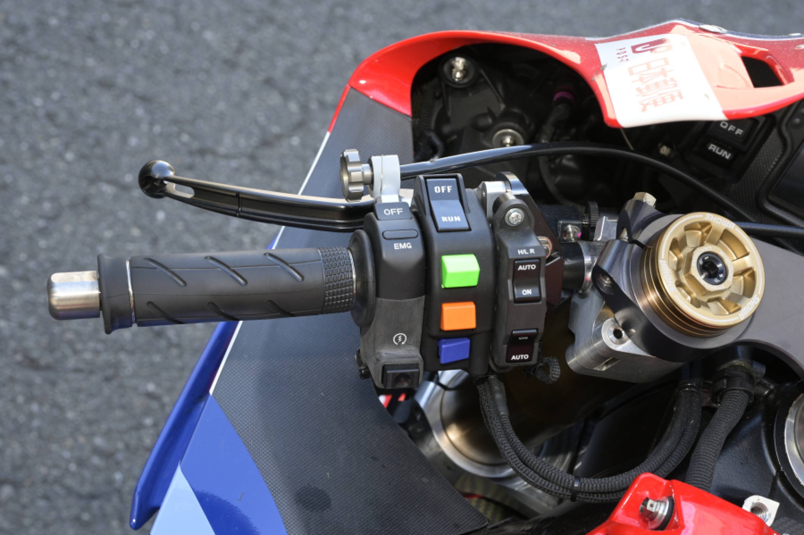 Left switch box: Green, yellow, and blue switches are for control mode selection; the black switch above them (marked OFF, RUN) is the pit lane switch